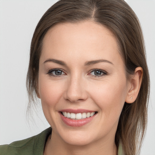 Joyful white young-adult female with long  brown hair and brown eyes