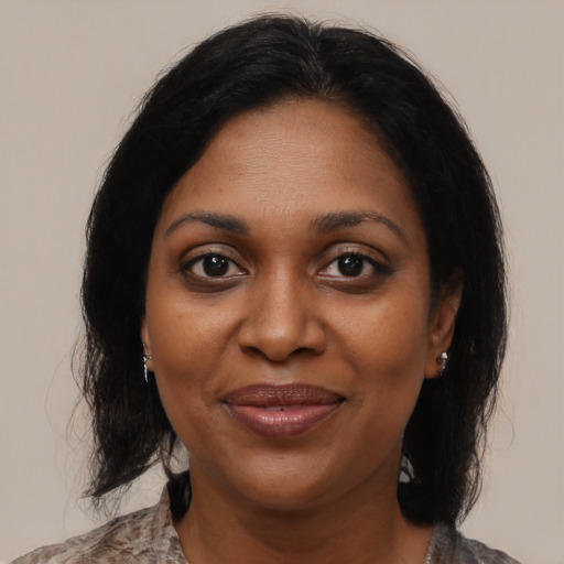 Joyful black adult female with medium  black hair and brown eyes