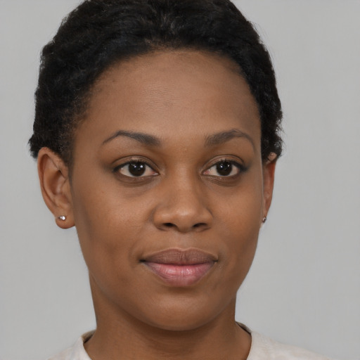 Joyful black young-adult female with short  brown hair and brown eyes