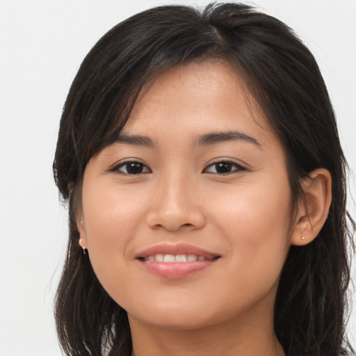 Joyful asian young-adult female with long  brown hair and brown eyes