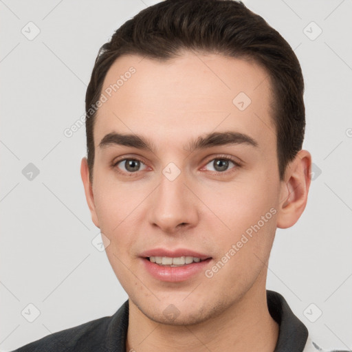 Joyful white young-adult male with short  brown hair and brown eyes