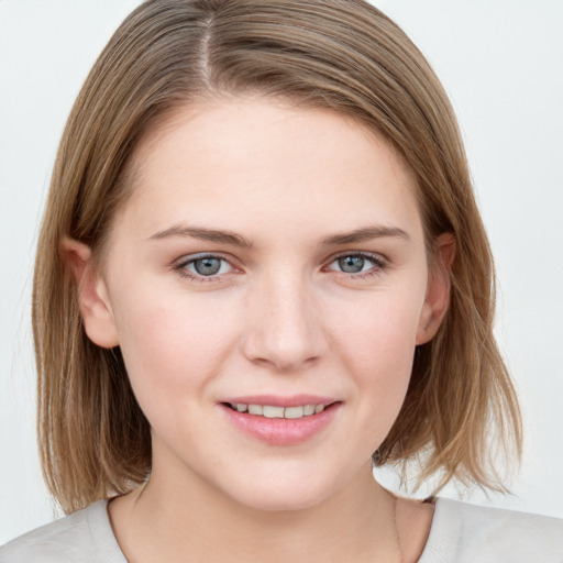 Joyful white young-adult female with medium  brown hair and blue eyes