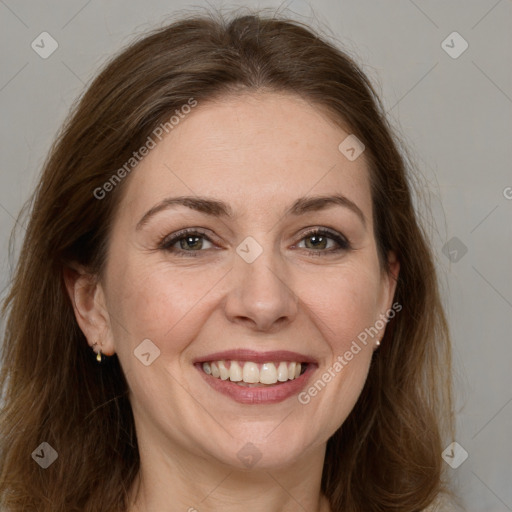 Joyful white adult female with long  brown hair and brown eyes