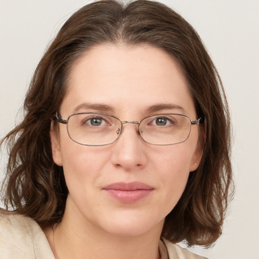 Joyful white young-adult female with medium  brown hair and green eyes