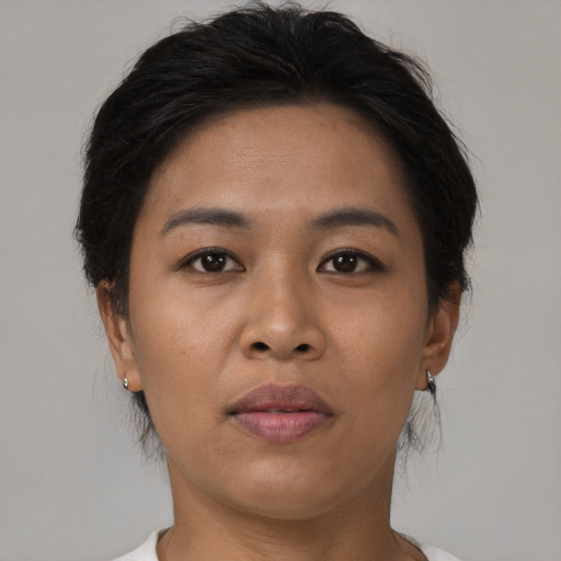 Joyful asian young-adult female with short  brown hair and brown eyes