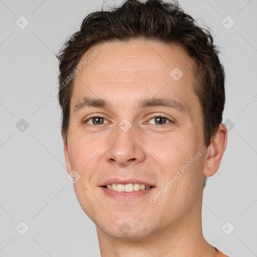 Joyful white adult male with short  brown hair and brown eyes