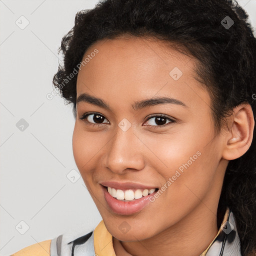 Joyful latino young-adult female with long  brown hair and brown eyes