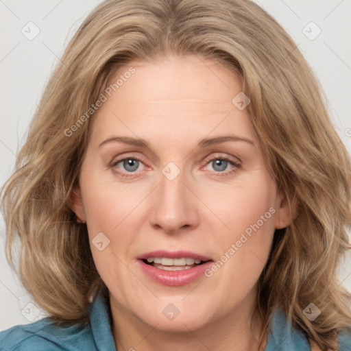 Joyful white adult female with medium  brown hair and blue eyes