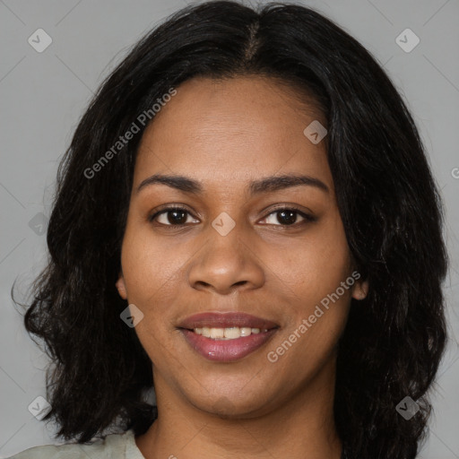 Joyful black young-adult female with long  black hair and brown eyes