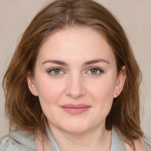 Joyful white young-adult female with medium  brown hair and blue eyes