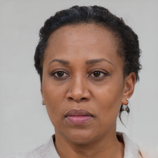 Joyful black adult female with short  brown hair and brown eyes