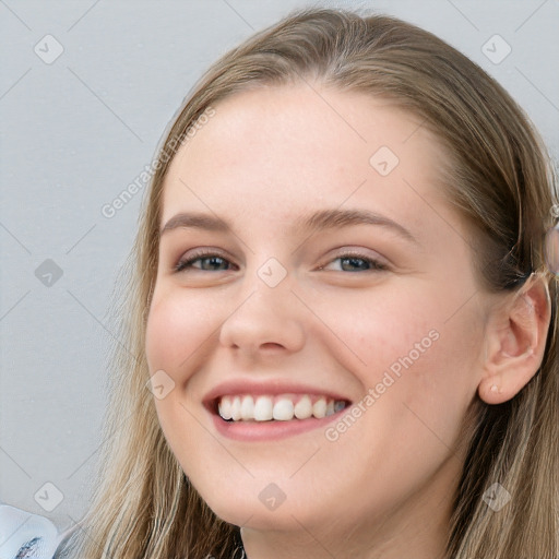 Joyful white young-adult female with long  brown hair and blue eyes