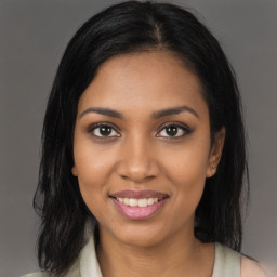 Joyful black young-adult female with medium  brown hair and brown eyes