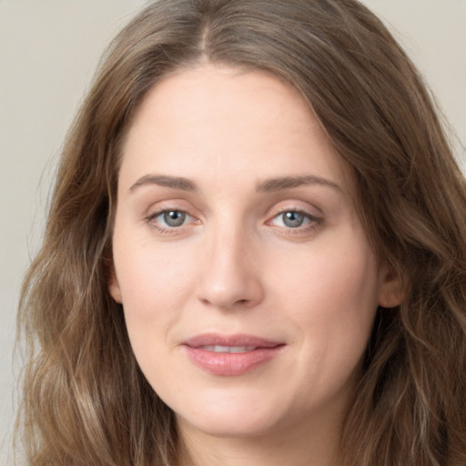 Joyful white young-adult female with long  brown hair and green eyes