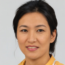 Joyful asian young-adult female with medium  brown hair and brown eyes