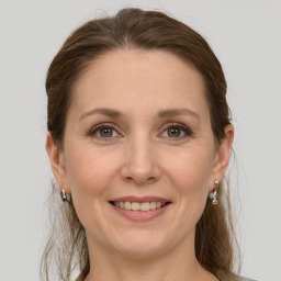 Joyful white adult female with medium  brown hair and grey eyes