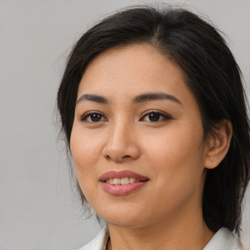 Joyful asian young-adult female with medium  brown hair and brown eyes