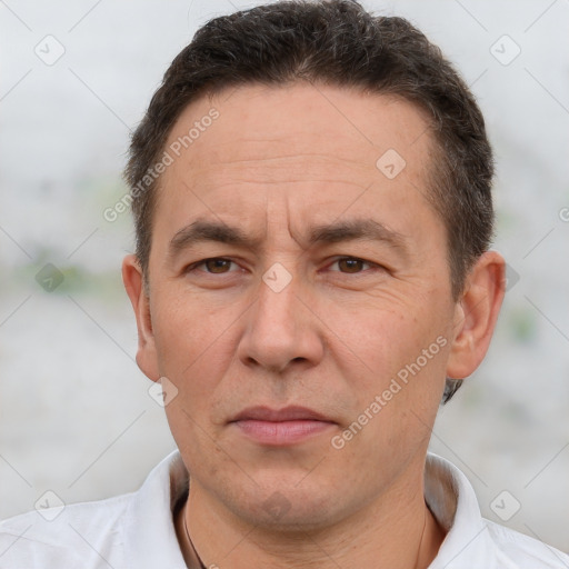 Joyful white adult male with short  brown hair and brown eyes