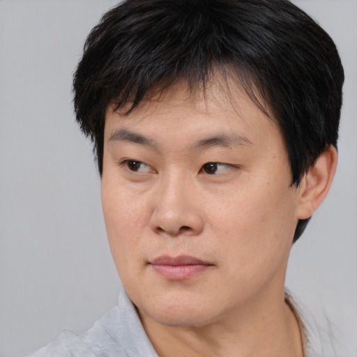 Neutral asian young-adult male with short  brown hair and brown eyes