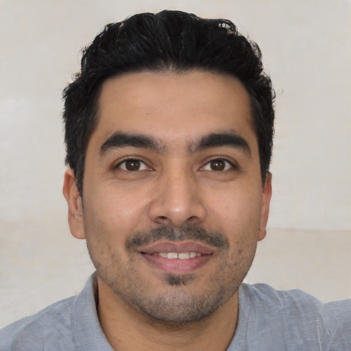 Joyful latino young-adult male with short  black hair and brown eyes
