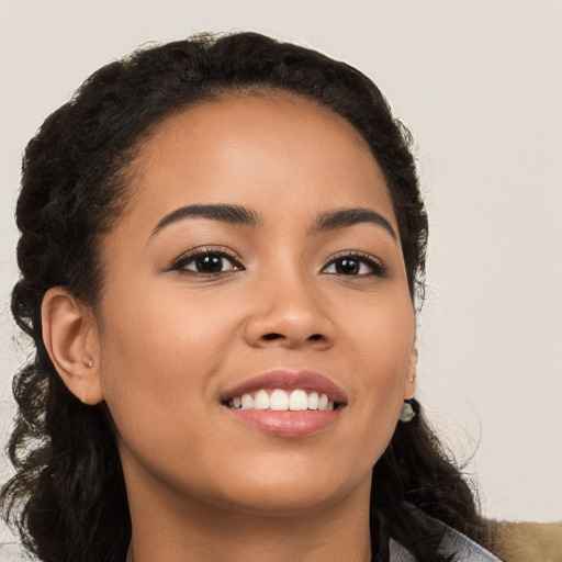 Joyful latino young-adult female with long  brown hair and brown eyes