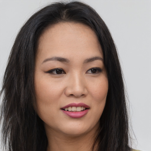 Joyful asian young-adult female with long  brown hair and brown eyes