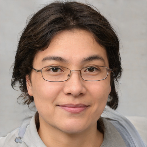 Joyful white adult female with medium  brown hair and brown eyes