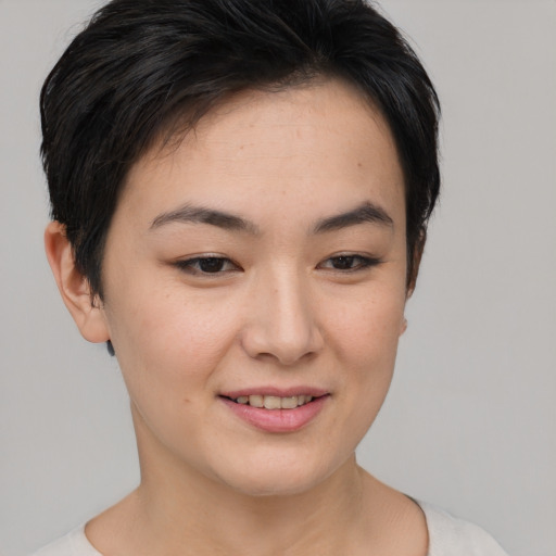Joyful asian young-adult female with short  brown hair and brown eyes