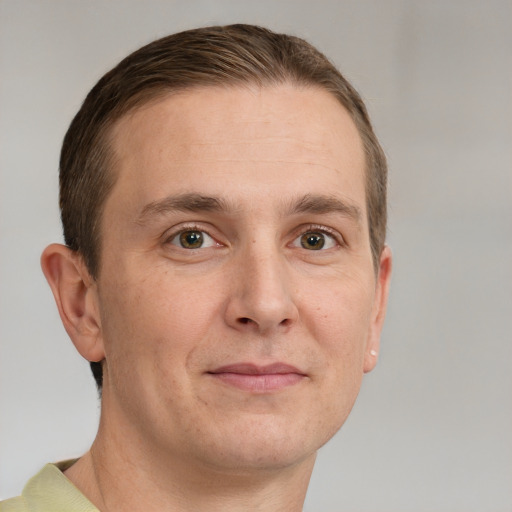 Joyful white adult male with short  brown hair and grey eyes