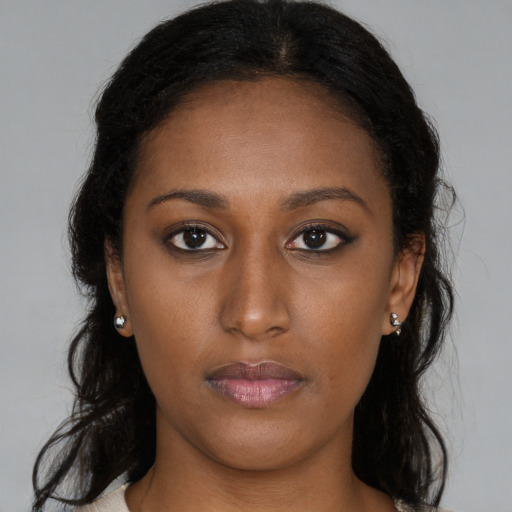 Neutral black young-adult female with long  brown hair and brown eyes