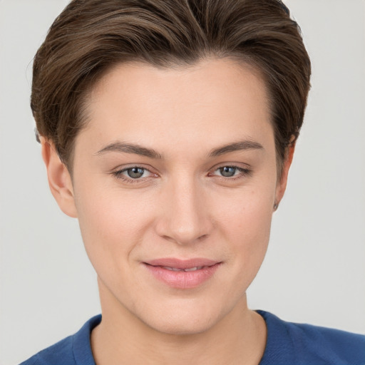 Joyful white young-adult female with short  brown hair and grey eyes