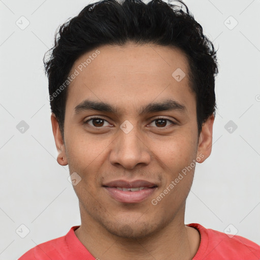 Joyful latino young-adult male with short  black hair and brown eyes