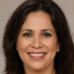 Joyful white adult female with long  brown hair and brown eyes