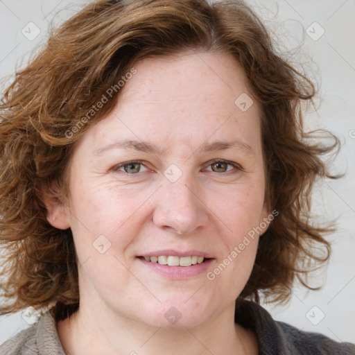 Joyful white adult female with medium  brown hair and blue eyes