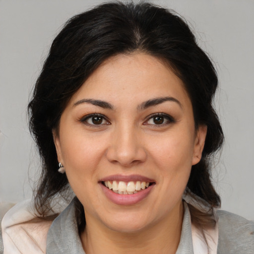 Joyful latino young-adult female with medium  brown hair and brown eyes