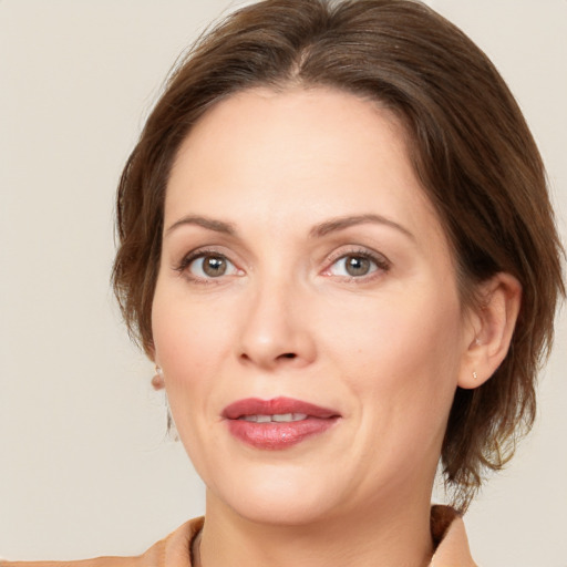 Joyful white adult female with medium  brown hair and brown eyes