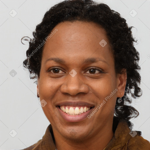 Joyful black adult female with long  brown hair and brown eyes