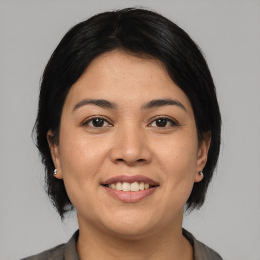 Joyful latino young-adult female with medium  black hair and brown eyes