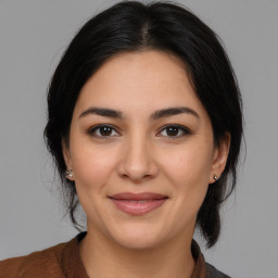 Joyful white young-adult female with medium  brown hair and brown eyes