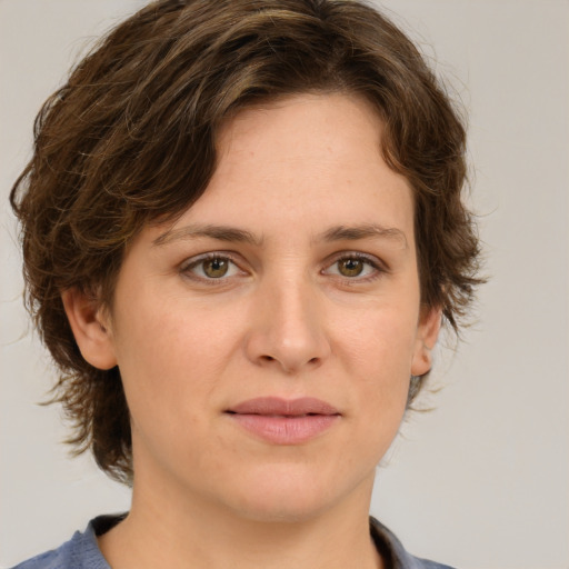 Joyful white young-adult female with medium  brown hair and green eyes