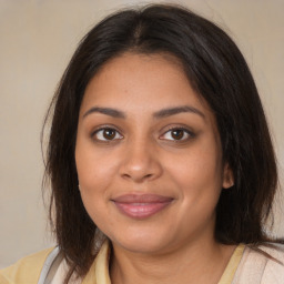 Joyful black young-adult female with medium  brown hair and brown eyes