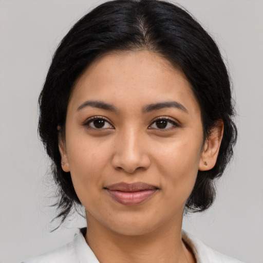 Joyful latino young-adult female with medium  black hair and brown eyes