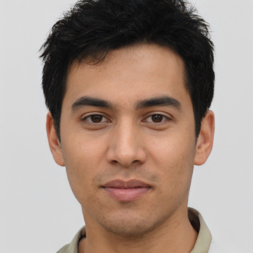 Joyful latino young-adult male with short  brown hair and brown eyes