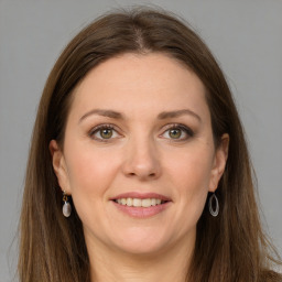 Joyful white young-adult female with long  brown hair and grey eyes