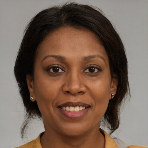 Joyful black adult female with medium  brown hair and brown eyes