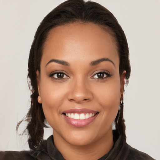 Joyful latino young-adult female with long  brown hair and brown eyes