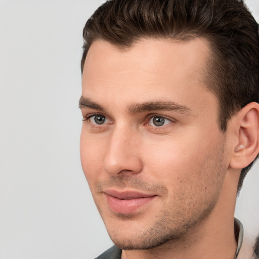 Joyful white young-adult male with short  brown hair and brown eyes