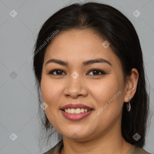 Joyful latino young-adult female with long  brown hair and brown eyes