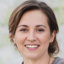 Joyful white young-adult female with medium  brown hair and brown eyes