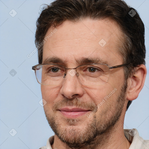 Joyful white adult male with short  brown hair and brown eyes